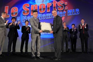 Le Sports Chairman Fei Gao presents Major League Baseball Commissioner Rob Manfred with a base that was used in the first MLB baseball exhibition game in China during the announcement of a partnership between Major League Baseball and Chinese sports network Le Sports Thursday, Jan. 6, 2016, at Caesars Palace in Las Vegas. Photo by Sam Morris