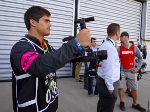 Clemson shot video using mostly DSLR cameras from Sony, Canon, and Nikon. Here, a student operator uses a Steadicam mount to capture smoother shots of the team entering the stadium.