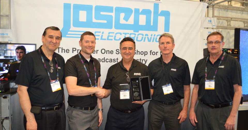 Joseph Electronics' President and CEO Yohay Hahamy (center) , along with other members of the JE family, accepts the award for Distributor of the Year from DirectOut.