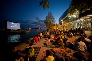 Audiences Watching Sail-in Cinema at Toronto's Sugar Beach