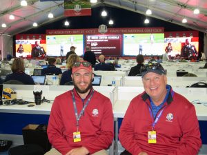 GoVision's Brett Ammon and Chris Curtis in front of the massive LED board inside the Ryder Cup Media Center.
