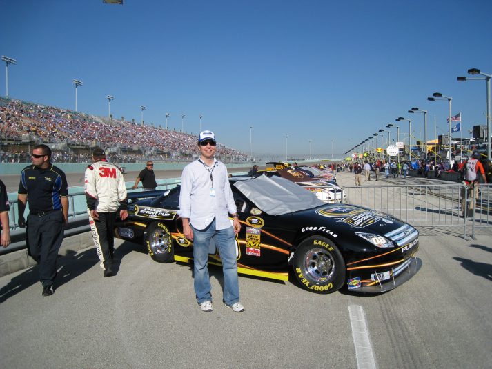 Andrew Heimbold takes time for a photo opp while onsite with DirecTV’s NASCAR HotPass in 2008.